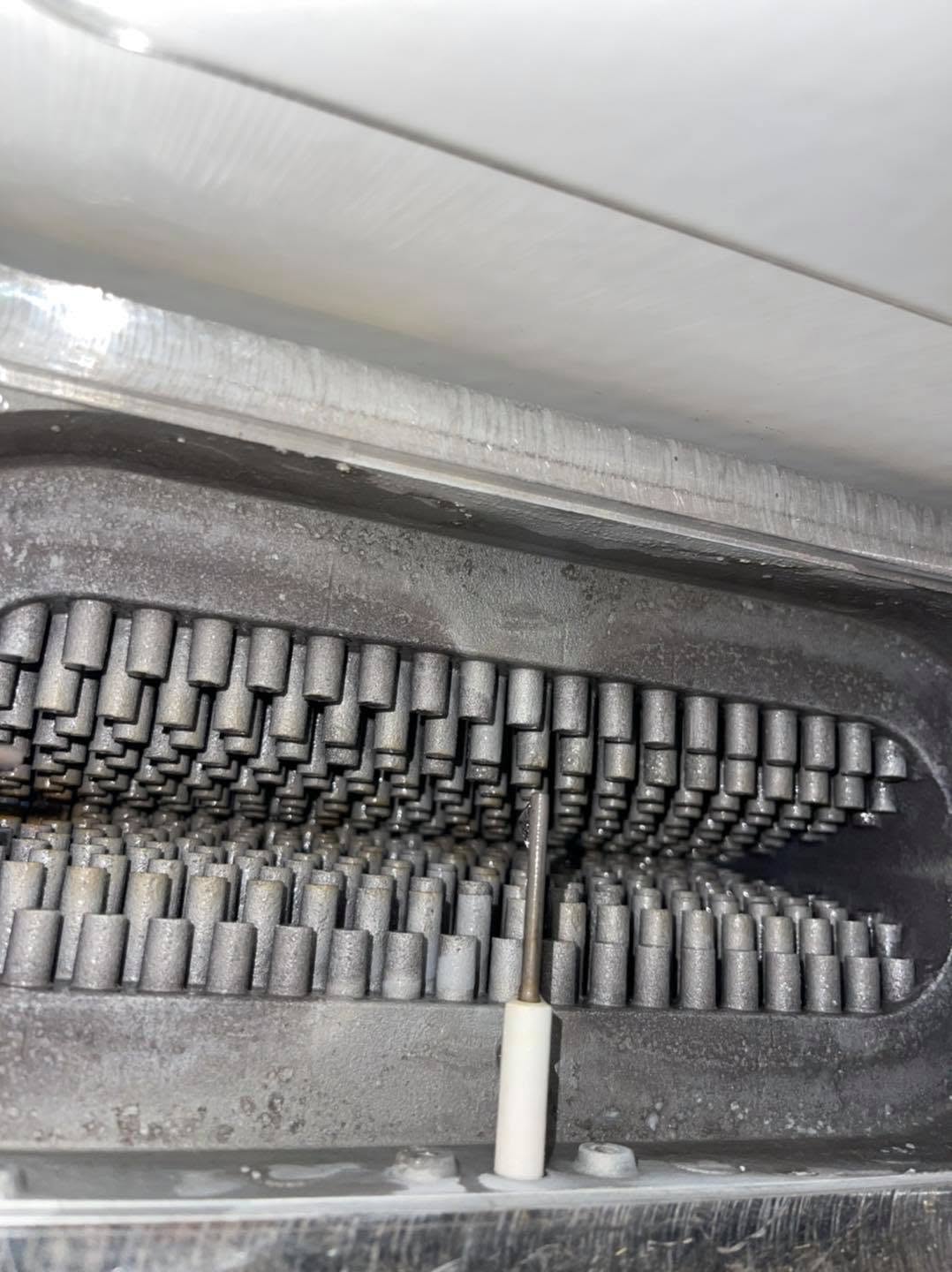 Close-up of heat exchanger pins inside a boiler