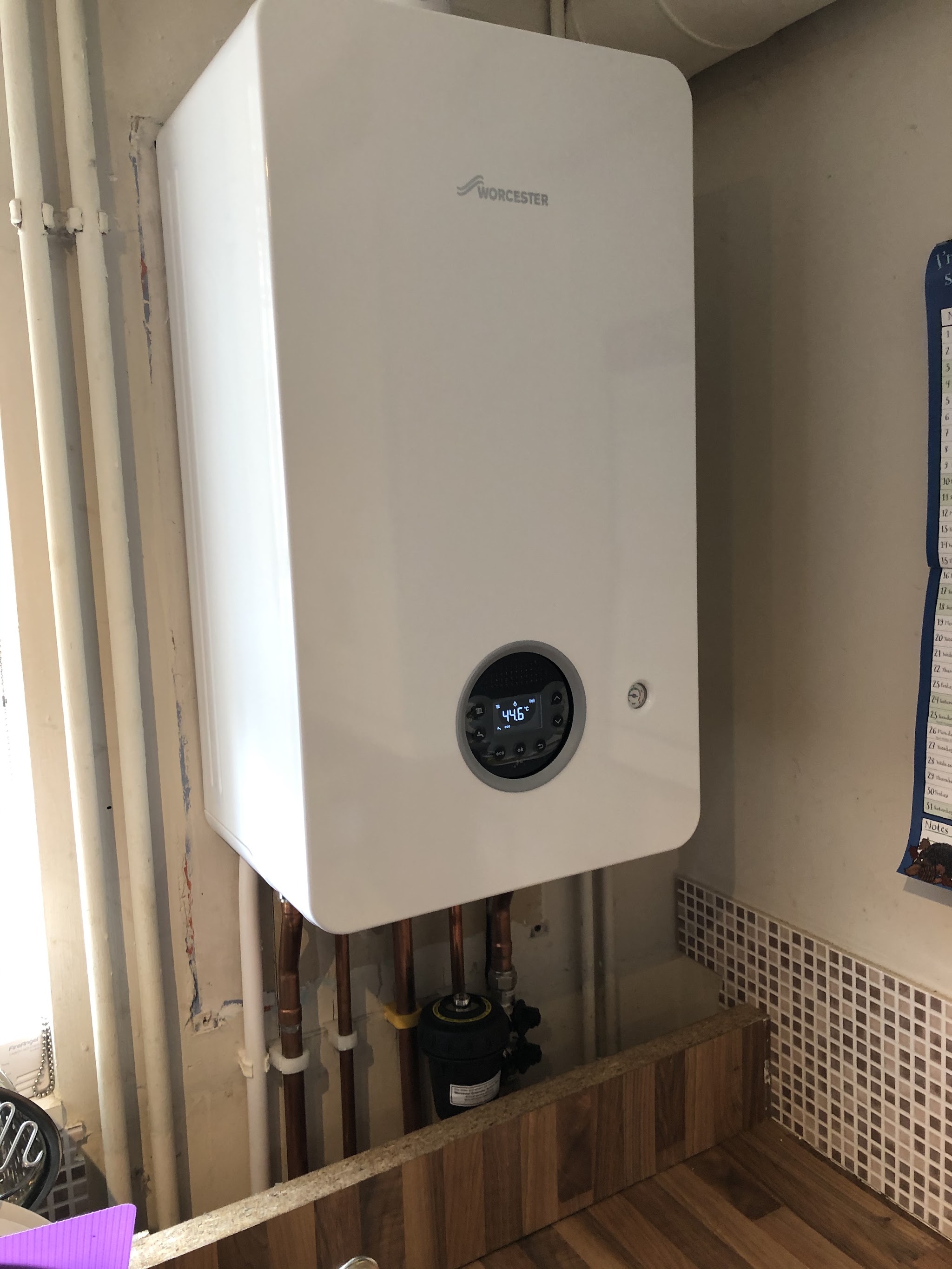 A newly fitted Worcester combi boiler with copper pipework and a system filter